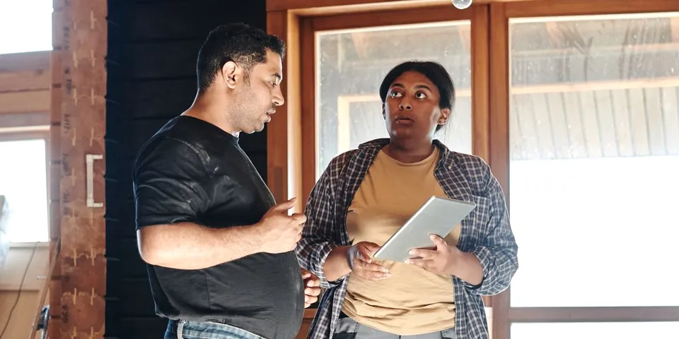 A contractor and a homeowner talking over a project